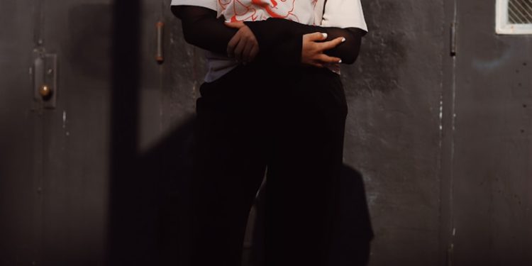a woman standing in front of a metal door