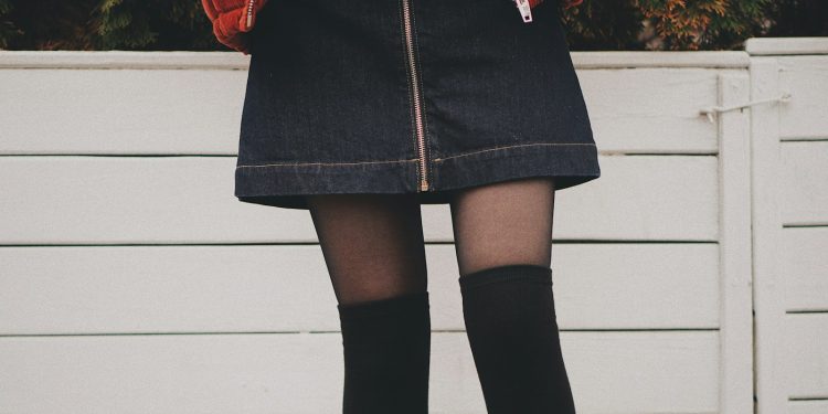 woman wearing black denim skirt and thigh high socks