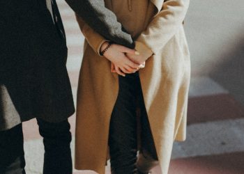 person in brown coat and black pants