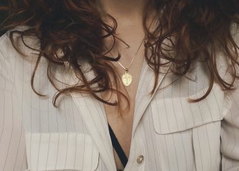 woman in white blazer with silver necklace