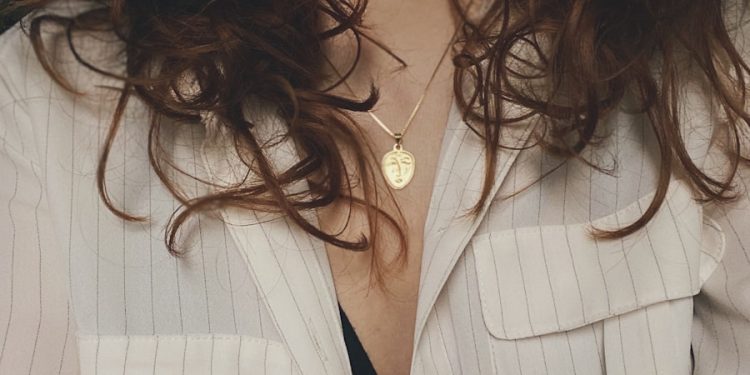 woman in white blazer with silver necklace