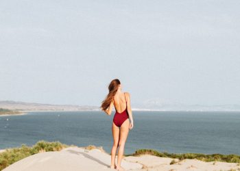 woman standing near mountain cliff