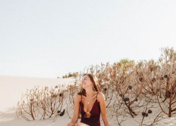 woman sitting on sand