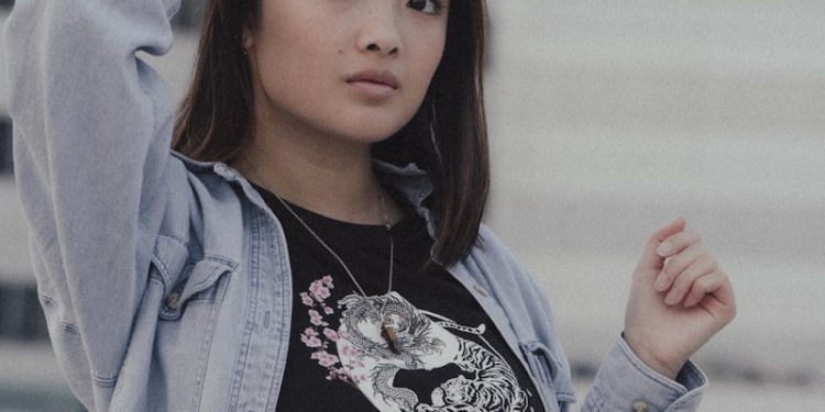 woman in black and white floral shirt and blue jacket